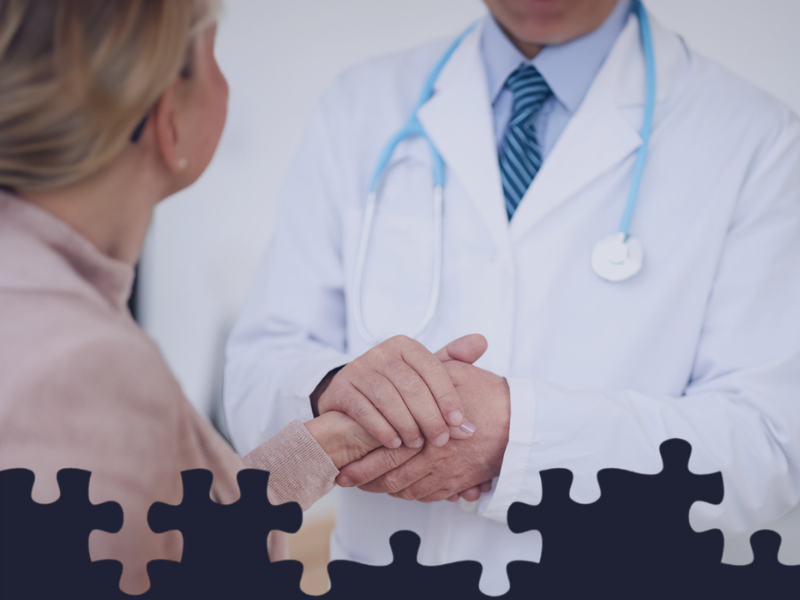 Doctor holding patient's hand